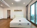 Spacious modern bedroom with a large window and minimalist decor