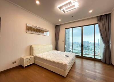 Modern bedroom with large window and city view