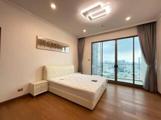 Modern bedroom with large window and city view