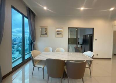 Modern dining area with large windows and city view