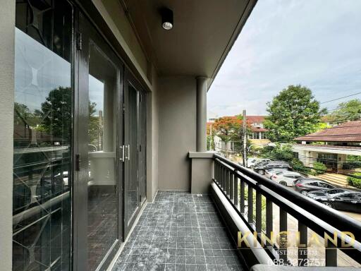 Spacious balcony with railing and view of the neighborhood