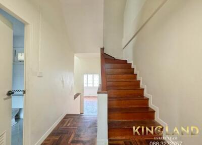 Wooden staircase in a well-lit hallway