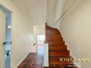 Wooden staircase in a well-lit hallway