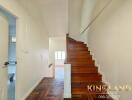 Wooden staircase in a well-lit hallway