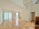 Spacious living room with tiled flooring and natural light