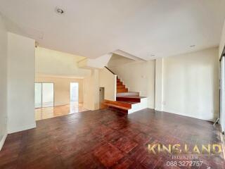 Spacious living room with wooden flooring and staircase