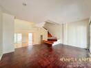 Spacious living room with wooden flooring and staircase