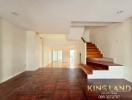 Spacious living room with wooden flooring