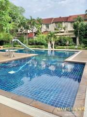 Outdoor pool area with adjacent residential building