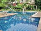 Outdoor pool area with adjacent residential building