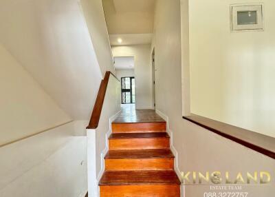 Staircase with wooden steps in a well-lit interior