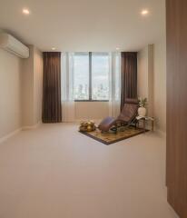 Living room with an armchair, air conditioning, and city view