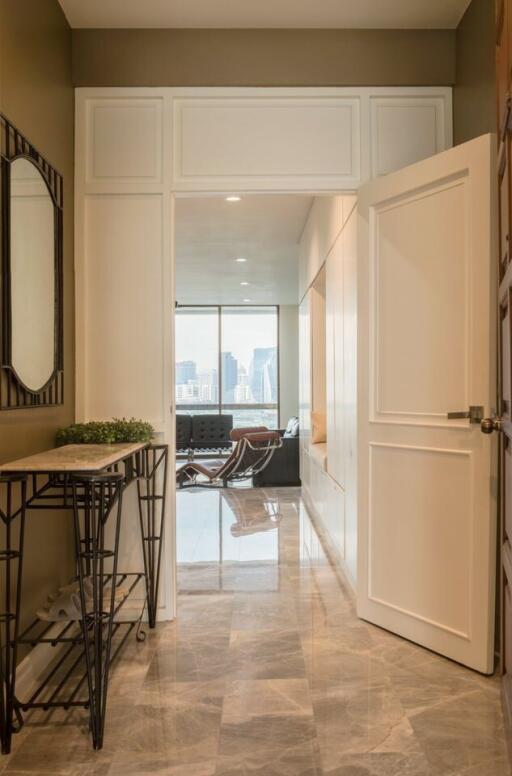 Apartment entrance with an open door and view of the living room