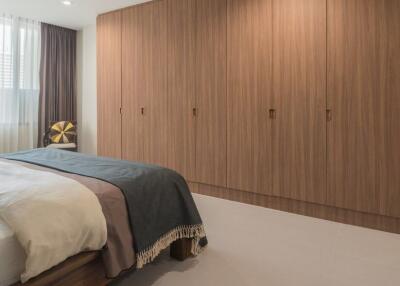 Spacious bedroom with large wooden wardrobe