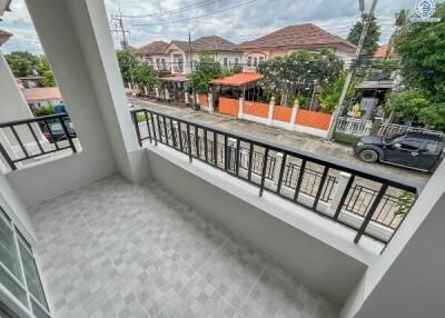 Balcony with a view of neighboring houses and streets.