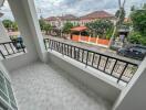 Balcony with a view of neighboring houses and streets.