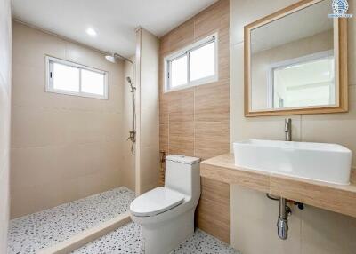 Modern bathroom with shower area and wooden accents