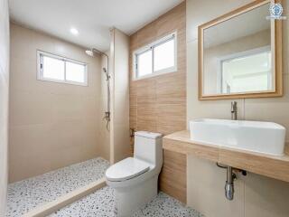 Modern bathroom with shower area and wooden accents