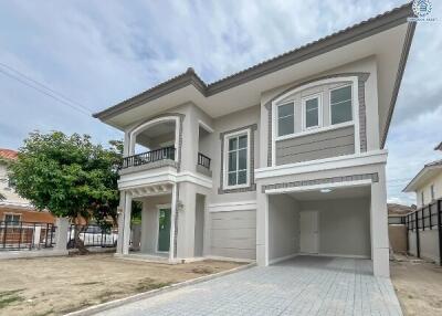 Exterior view of a two-story house with a garage and driveway