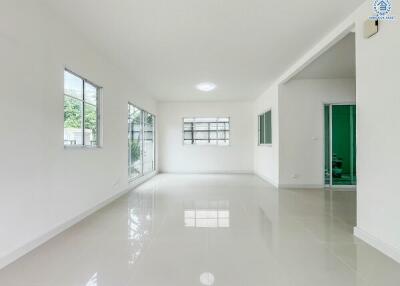 Spacious white living room with large windows