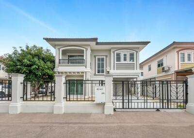 Front view of a modern house with fenced yard