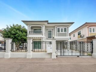 Front view of a modern house with fenced yard