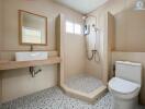 Modern bathroom with a shower, toilet, and sink.