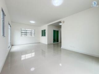 Spacious main living area with large windows and glossy tile flooring