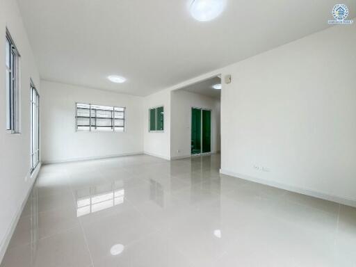 Spacious main living area with large windows and glossy tile flooring