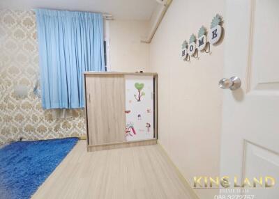 Bedroom with blue curtains, a wall cabinet, and a decorative 