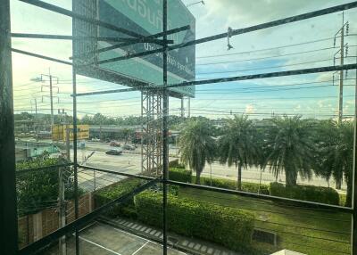 Building exterior view with large glass windows and road