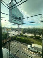 Building exterior view with large glass windows and road