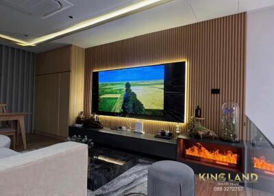 Modern living room with wall-mounted TV and electric fireplace