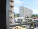 View of neighboring buildings and clear sky from a balcony