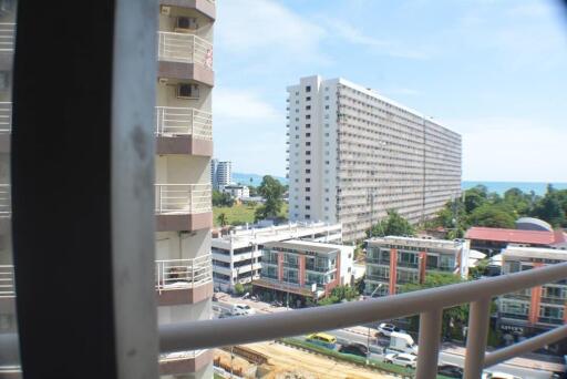 View of neighboring buildings and clear sky from a balcony