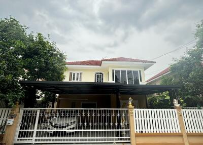 Front view of a two-story house with a gated entrance