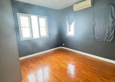 empty bedroom with wooden floor and air conditioning