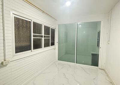 Clean white room with tiled floor and large windows