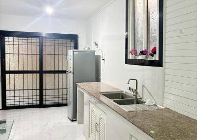 Modern kitchen with stainless steel appliances and granite countertops