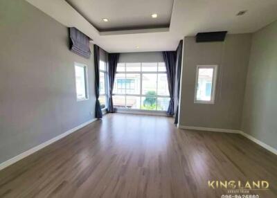 Modern living room with large windows and wood flooring