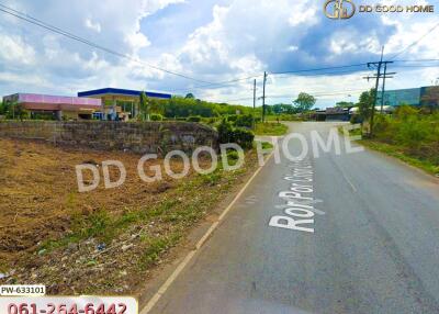 Street view with a gas station in the background