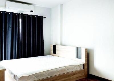 Modern bedroom with wooden floor and bed frame