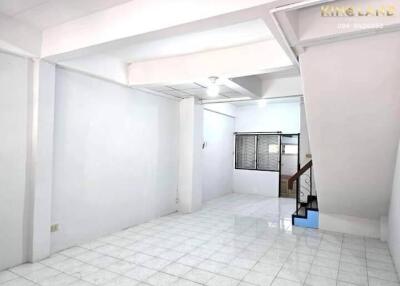 Main living area with tiled floor and stairway