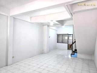 Main living area with tiled floor and stairway