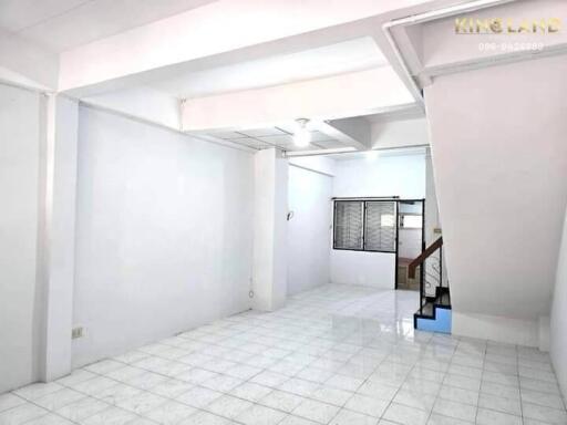 Main living area with tiled floor and stairway