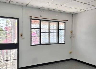 Empty living room with large window and door