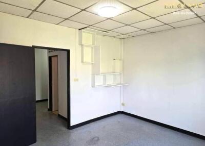 Empty bedroom with white walls and ceiling light