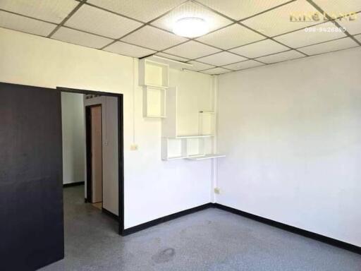 Empty bedroom with white walls and ceiling light