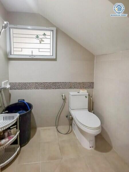 Bathroom with toilet and a small window