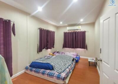 Cozy bedroom with double bed and purple curtains